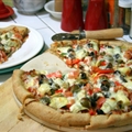 Pizza with Red & Green Peppers, Onions, Artichoke Hearts, and Olives