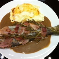 Bacon-wrapped trout with onion compote (Epicurious)