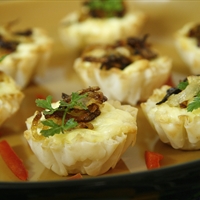 CARAMELIZED ONION AND GOAT CHEESE TARTLETS