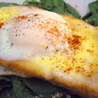 Poached Eggs and Parmesan Cheese Over Toasted Brioche with Pistou