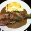 Bacon-wrapped trout with onion compote (Epicurious)