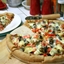 Pizza with Red & Green Peppers, Onions, Artichoke Hearts, and Olives